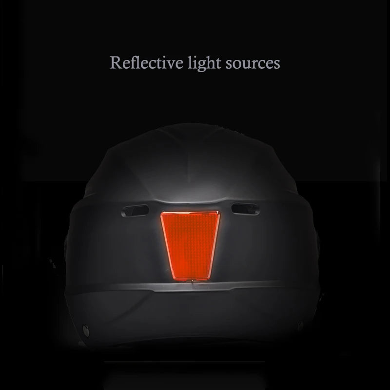 Back of a vehicle with a reflective orange light source on a black background